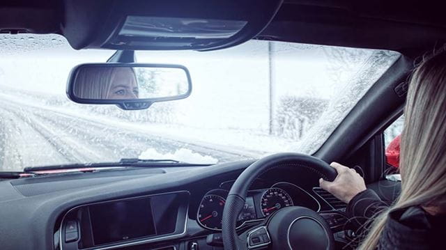 Winter driving tips woman car snowy